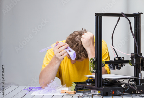 Man fighting with a 3D printer