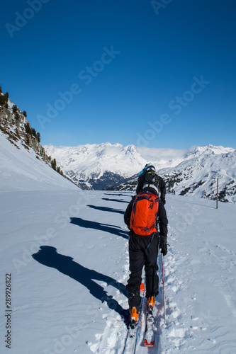 Backcountry skiers hiking to the next line down the mountain in the French alps of Les Arcs.