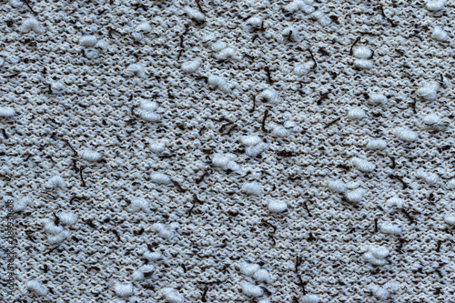 Background in the form of a knitwear with soft white boucle and dark brown veins on a light background