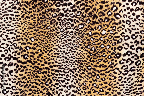 Background in the form of a knitwear product with a pattern similar to a leopard skin in cream brown tones