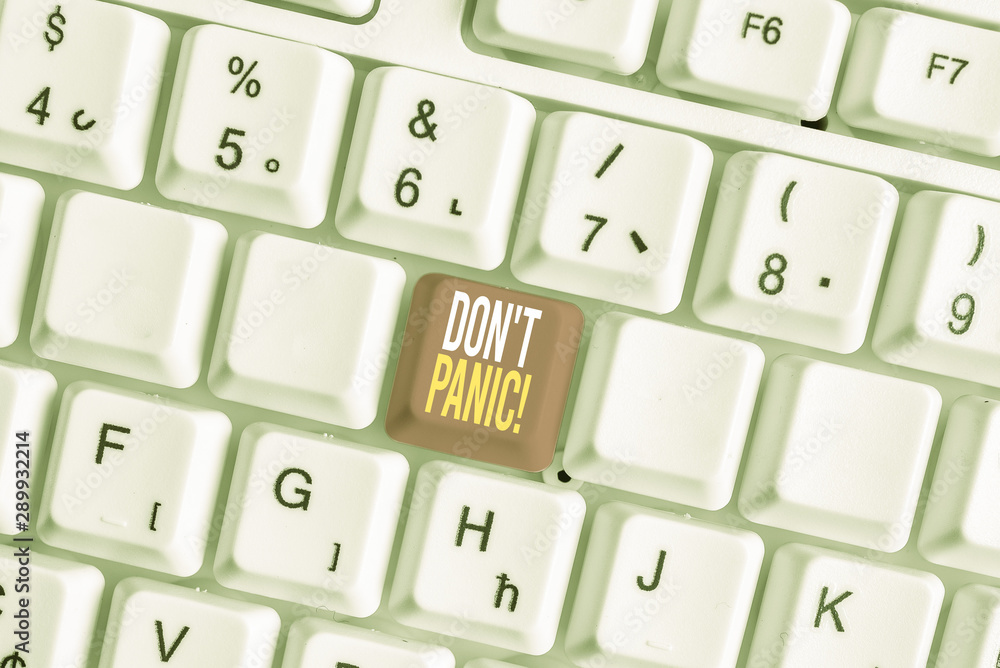Word writing text Don T Panic. Business photo showcasing suddenly feel so worried or frightened that you can not behave White pc keyboard with empty note paper above white background key copy space
