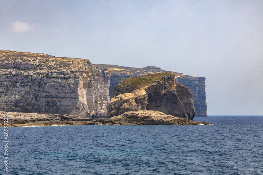 Panorama view at the coast of Dwejra Bay with the Fungus Rock on Gozo island in Malta Panorama view at the coast of Dwejra Bay with the Fungus Rock on Gozo island in Malta