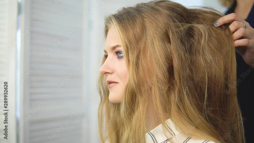Slow-motion shooting close-up of a long dark hair of a young girl. Brilliant and silky hair after keratin straightening. The effect of keratin, straight hair. The concept of beauty salons, beauty. Slow-motion shooting close-up of a long dark hair of a young girl. Brilliant and silky hair after keratin straightening. The effect of keratin, straight hair. The concept of beauty salons, beauty.