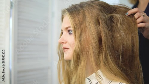 Slow-motion shooting close-up of a long dark hair of a young girl. Brilliant and silky hair after keratin straightening. The effect of keratin, straight hair. The concept of beauty salons, beauty.