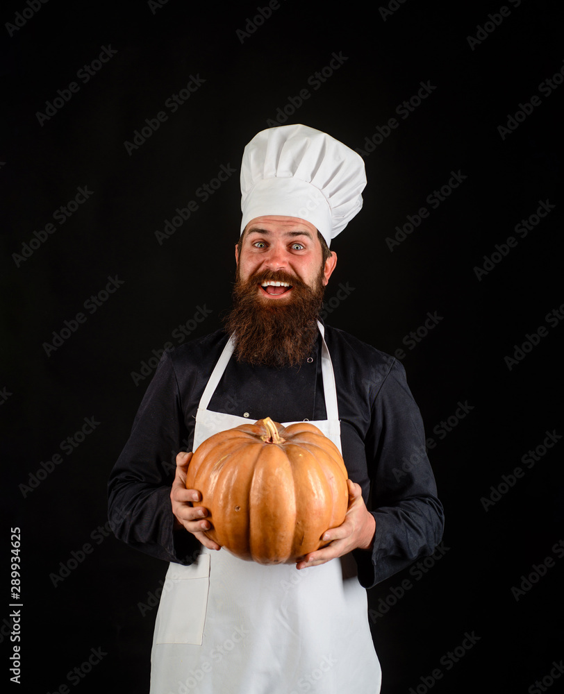 Diet food. Fresh Pumpkin. Harvest pumpkin. Chef preparing meal in kitchen. Healthy vegetarian eating. Autumn vegetables. Big pumpkin for Halloween. Bearded cook in chef hat with pumpkin. Farm market. Diet food. Fresh Pumpkin. Harvest pumpkin. Chef preparing meal in kitchen. Healthy vegetarian eating. Autumn vegetables. Big pumpkin for Halloween. Bearded cook in chef hat with pumpkin. Farm market.