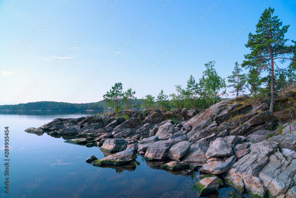 Rocky shore of the island on the lake . Ladoga Skerries, Karelia. Rocky shore of the island on the lake . Ladoga Skerries, Karelia.