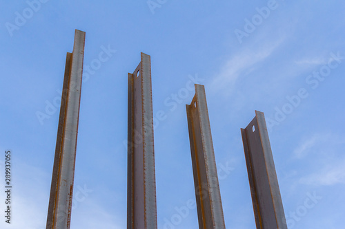 Steel channel on a background of blue sky. The use of steel channel to strengthen the foundation of the house in a construction site.