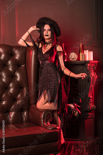  Charming witch in a dark room on Halloween