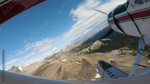 airplane flying over mountains photo