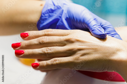 Female hand with manicure in the salon.