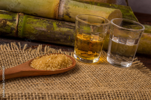 Cachaça is the name of a typical alcoholic drink produced in Brazil maked with sugarcane. Traditional drink from Brazil on wooden table