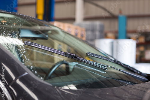 Detailed view of car windshield wipers while they are being used