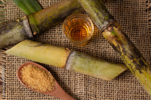 Cachaça is the name of a typical alcoholic drink produced in Brazil maked with sugarcane. Traditional drink from Brazil on wooden table