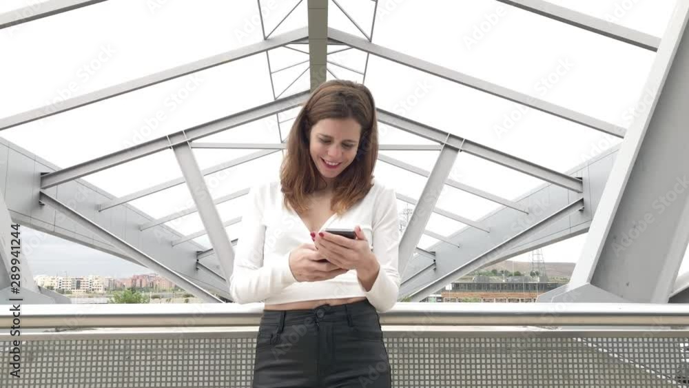 Attractive woman smiling using smart phone. Communication concept Attractive woman smiling using smart phone. Communication concept