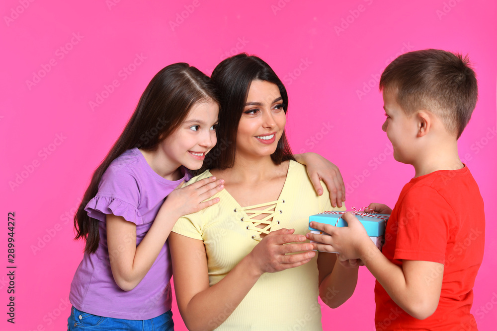 Son and daughter congratulating mom on color background. Happy Mother's Day Son and daughter congratulating mom on color background. Happy Mother's Day