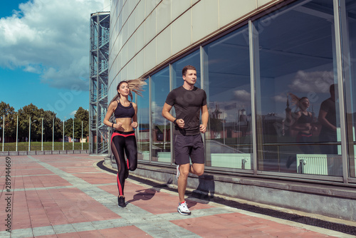 Sports couple friends man woman, jogging summer, sportswear, morning afternoon bright sunny day. Active lifestyle, fitness motivation workout. Athletes are strong and resilient in movement.