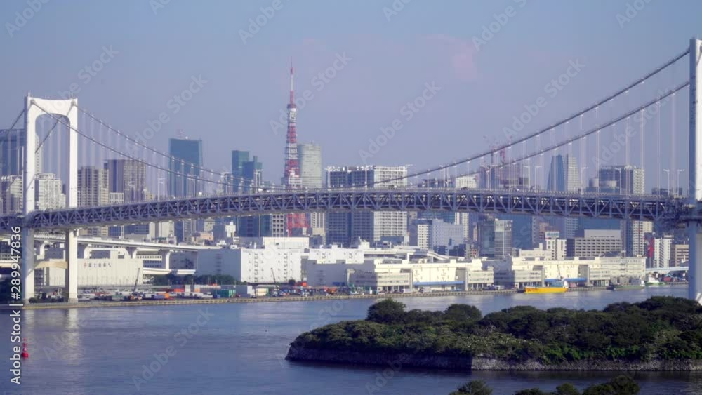 Wide shot of cars commuting across the Rainbow Bridge in Tokyo, Japan. Wide shot of cars commuting across the Rainbow Bridge in Tokyo, Japan.