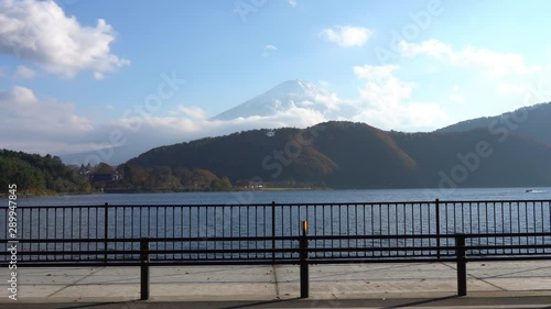 Wallpaper Mural Panning shot of mountains and a lake next to a boardwalk, Mount Fuji in the background on a bright sunny day. Torontodigital.ca