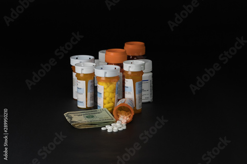 Prescription drugs pill bottles and money