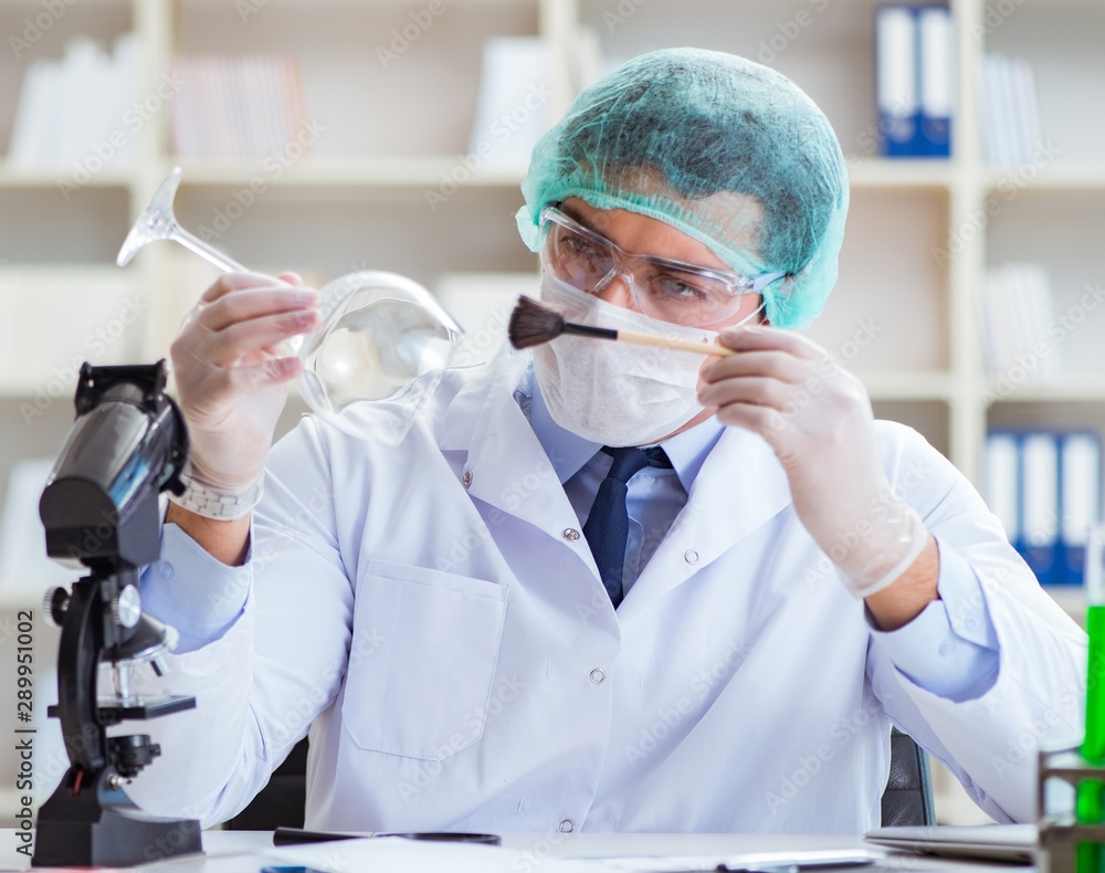 Forensics investigator working in lab on crime evidence Forensics investigator working in lab on crime evidence
