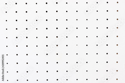фотографія peg board background and texture. white board with holes.