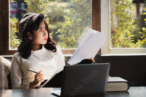 Asia woman using  laptop computer  working,playing with fun and happy. photo