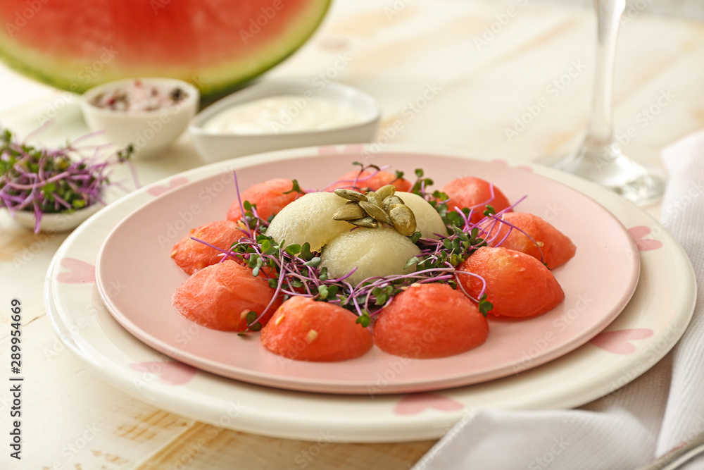 Plate with tasty salad on table Plate with tasty salad on table