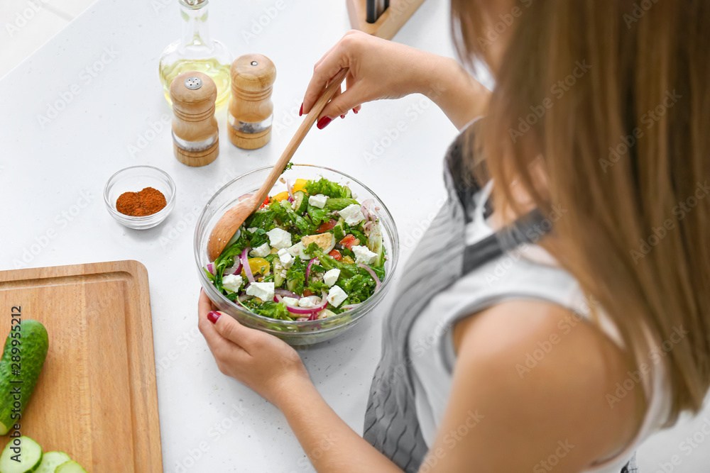 Plakat Woman preparing fresh salad at table, closeup