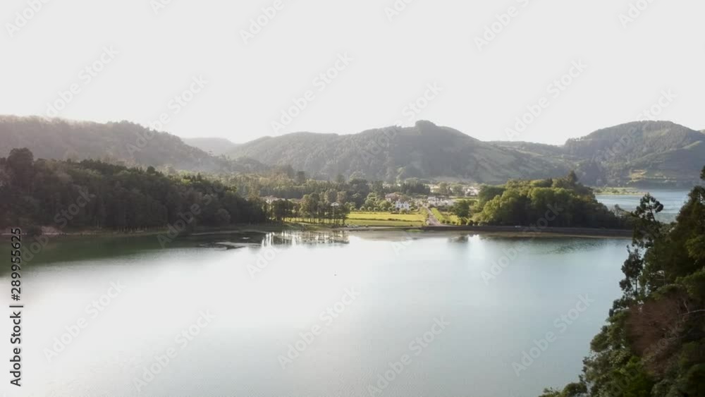 A volcanic crater becomes a beautiful lake with lush green edges in Sete Cidade Azores. Aerial reveal shot. A volcanic crater becomes a beautiful lake with lush green edges in Sete Cidade Azores. Aerial reveal shot.