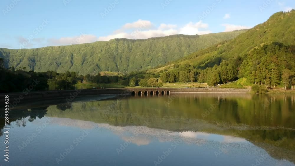 The historic Ponte Dos Regos Bridge built with stone arches over the tranquil lakes of Sete Cidades. The historic Ponte Dos Regos Bridge built with stone arches over the tranquil lakes of Sete Cidades.