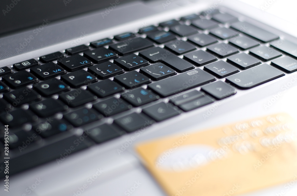 Laptop Keyboard with Out of Focus Gold Credit Card Laptop Keyboard with Out of Focus Gold Credit Card