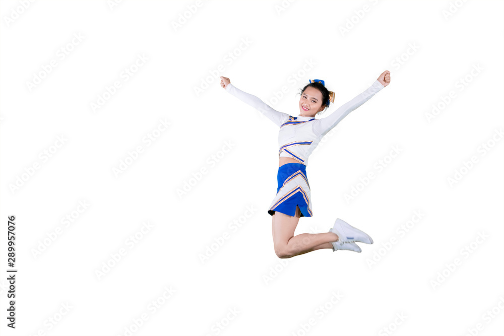 Beautiful cheerleader leaping with copy space Beautiful cheerleader leaping with copy space