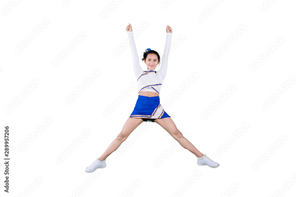 Cheerleader girl jumping in the studio