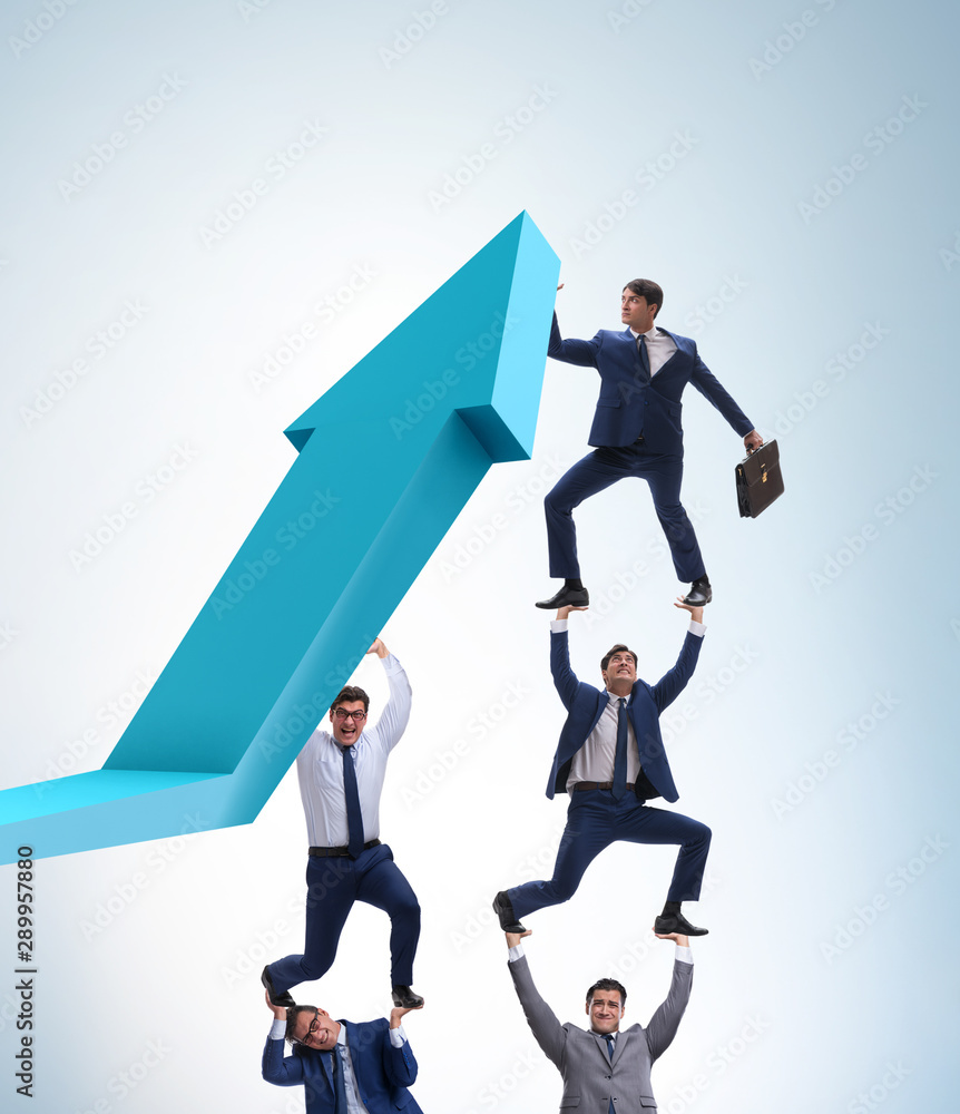 Businessman supporting growtn in economy on chart graph Businessman supporting growtn in economy on chart graph