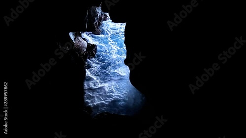 Hawaii -Filming the waves coming into a hole in the cliffs photo