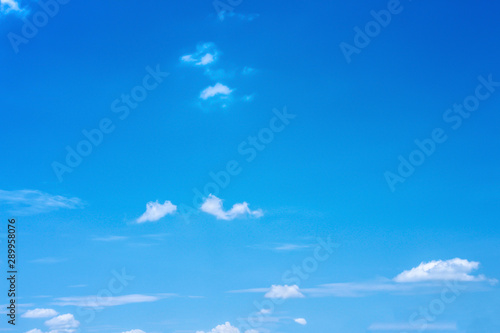 Bright blue sky with clouds and light wind on background