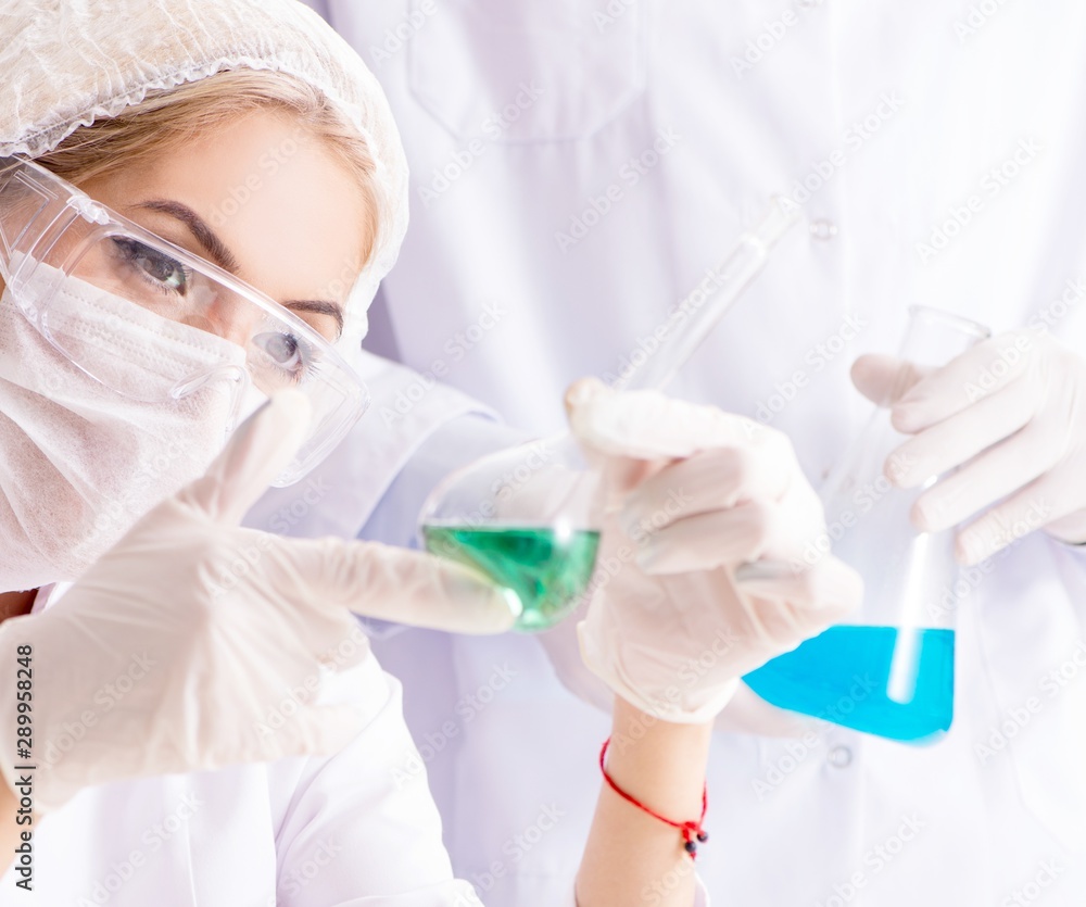 Young woman chemist working in clinic lab Young woman chemist working in clinic lab