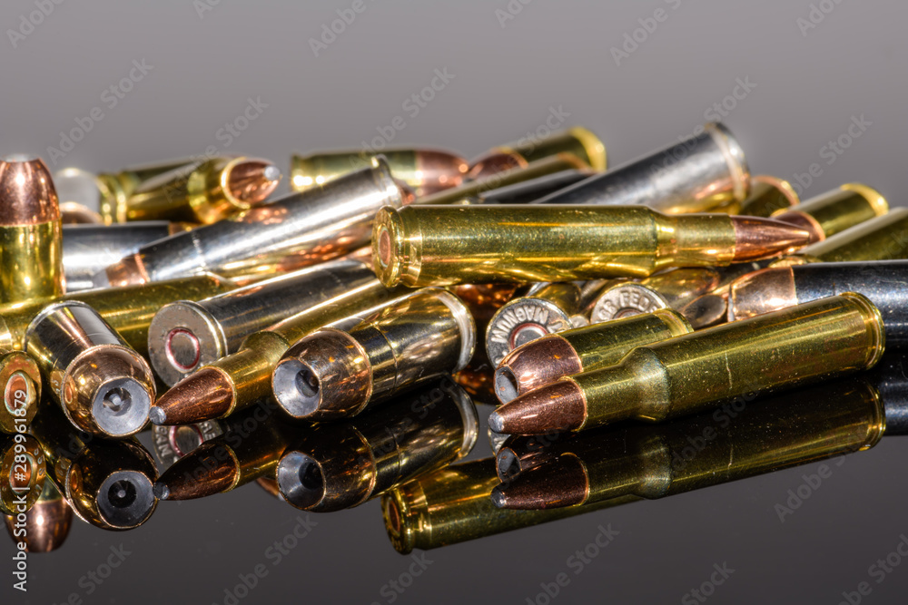 Naklejka premium Miscellaneous semi-automatic handgun and rifle ammunition on black background,