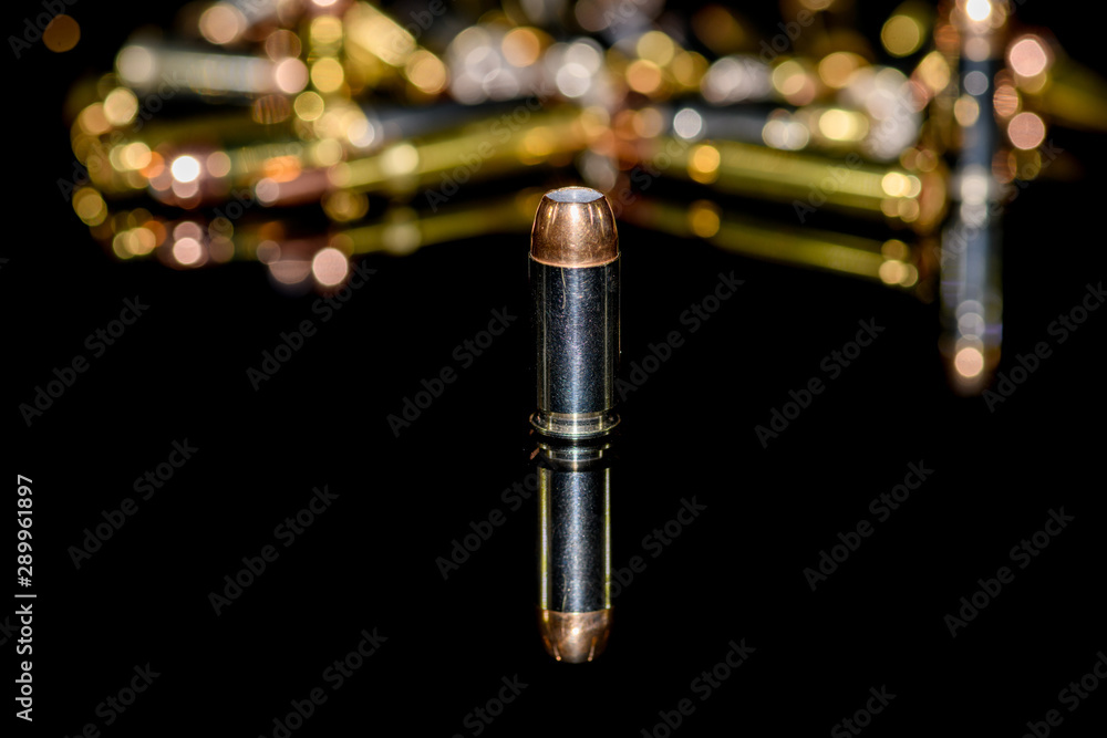 Naklejka premium 40 caliber semi-automatic handgun ammunition on black background, selective focus
