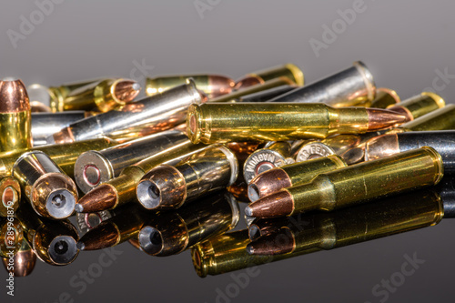 Foto Miscellaneous semi-automatic handgun and rifle ammunition on black background,