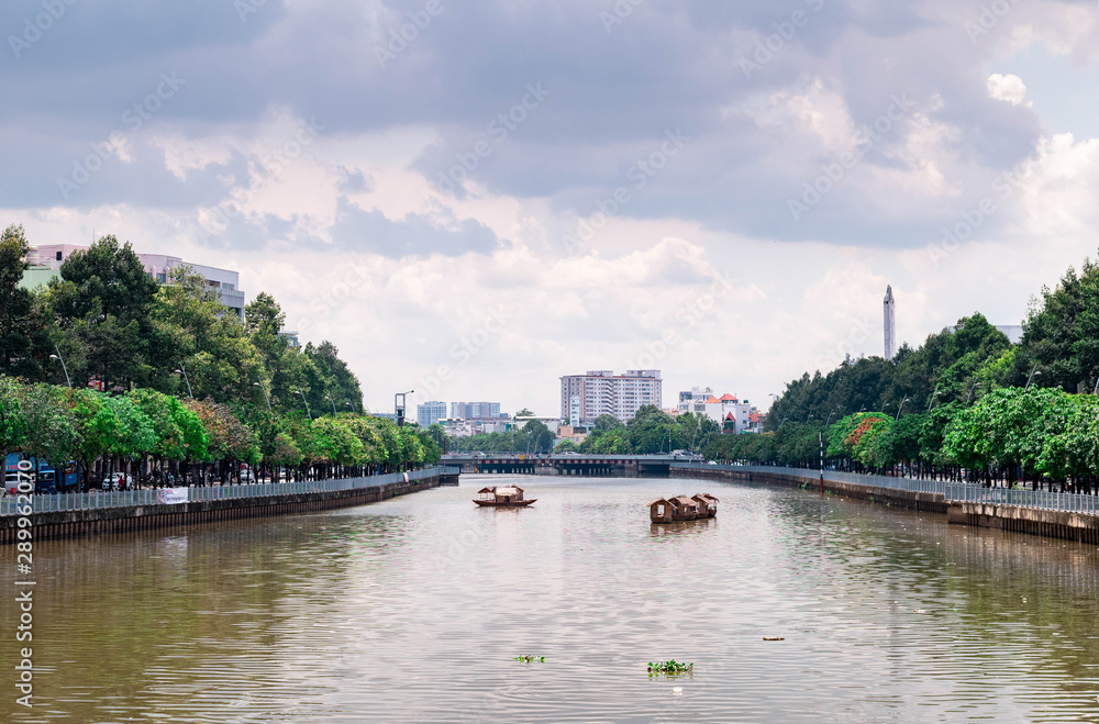 Ho Chi Minh city landscape, river with high rise building on the background during the day.