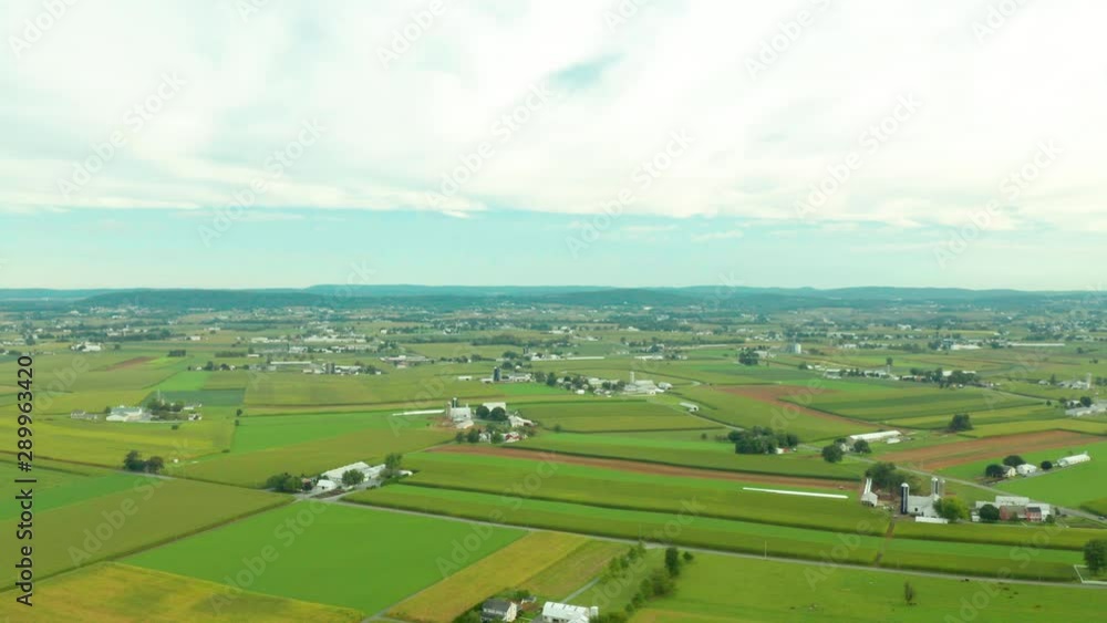 Aerial View of Rural Farmland In Pennsylvania with Barns, Silos, Corn Fields and Rolling Hills Aerial View of Rural Farmland In Pennsylvania with Barns, Silos, Corn Fields and Rolling Hills