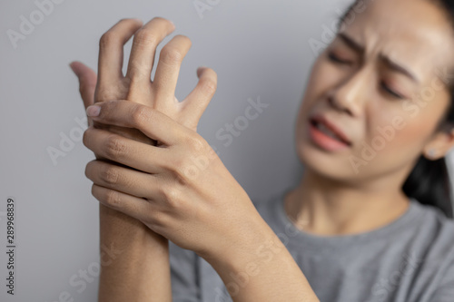 Woman suffering from pain in hand.