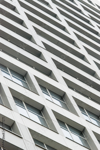 Texture of a skyscraper, walls of a high-rise building with windows.