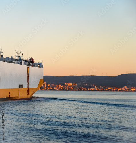Fotografie Half v'ew Large RORO ship or oceangoing vehicle carrier ship sailing in the sea