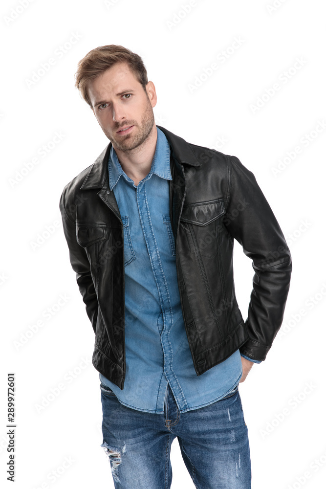man standing with hands behind his back man standing with hands behind his back