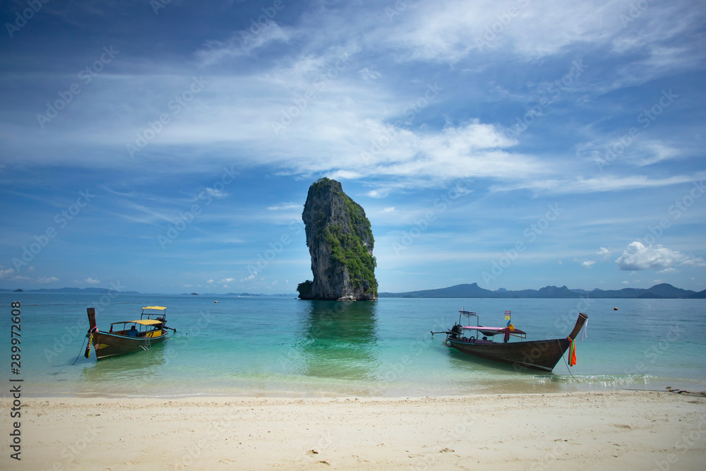 Traditional longtail boat and Poda island, Thailand.