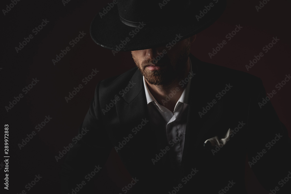 close up of mysterious young man in tuxedo on black background close up of mysterious young man in tuxedo on black background