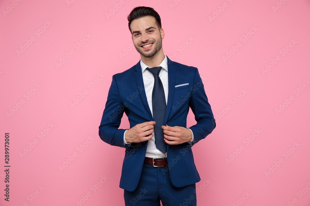 attractive young man wearing blue navy suit on pink background attractive young man wearing blue navy suit on pink background