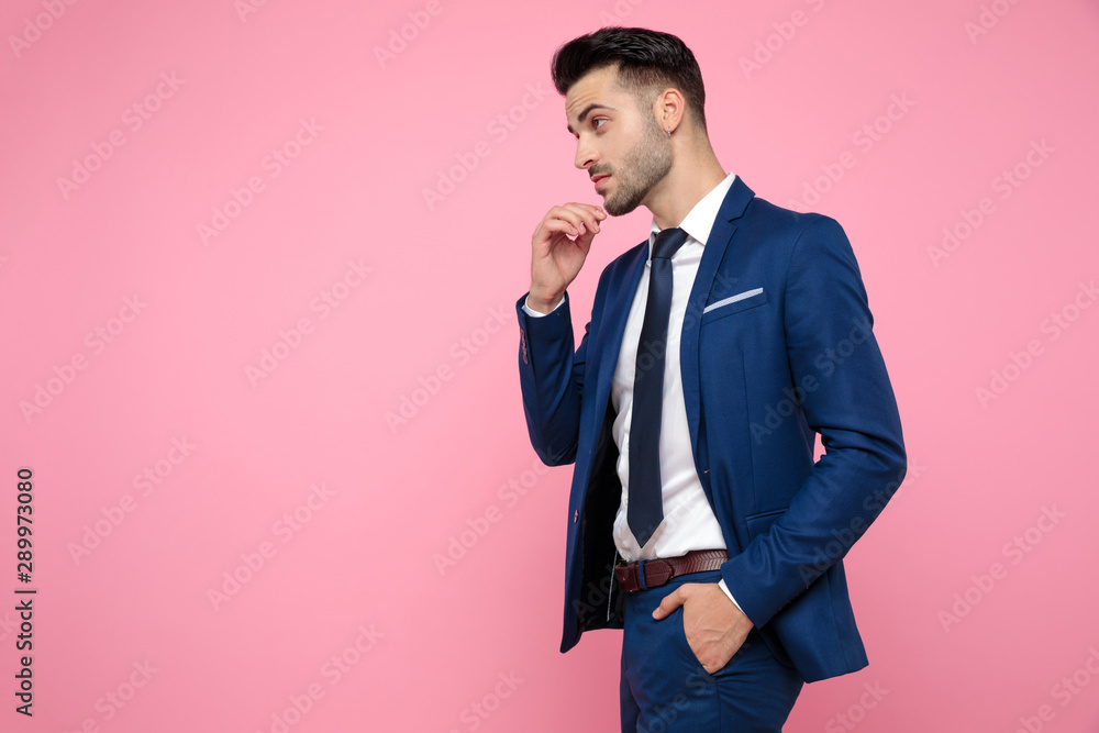 attractive young man thinking on pink background attractive young man thinking on pink background